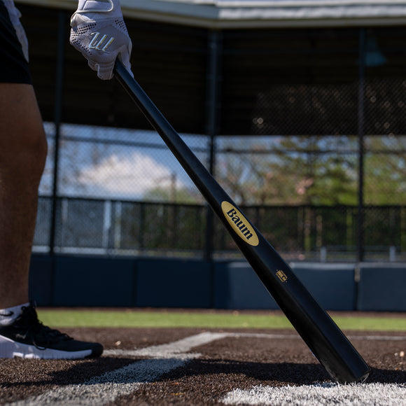 Player at bat with the Baum Bat Standard Gold Stock Maple Baseball Bat