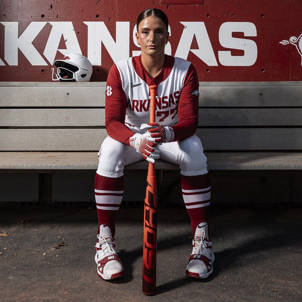 Arkansas' Bri Ellis sitting in the dugout with the 2026 Easton Ghost® Advanced Fastpitch Bat