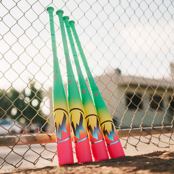 2026 Easton Hype Fire® USA Baseball Bats resting against a fence