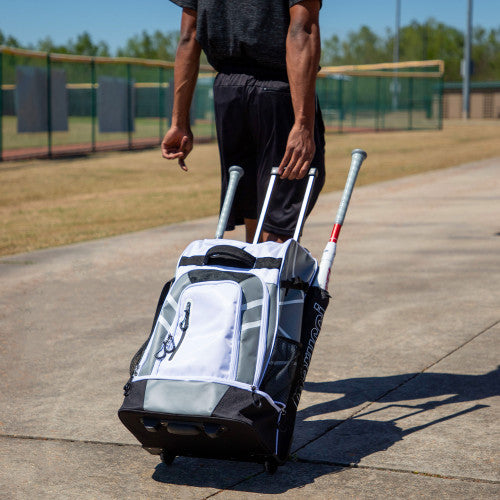 Player rolling the Marucci Convoy Wheeled Bag
