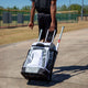 Player rolling the Marucci Convoy Wheeled Bag