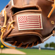 Close-up of the Nokona U.S. Flag logo on the Nokona Walnut Edge™ Precision 33.5" Baseball Catchers Mitt