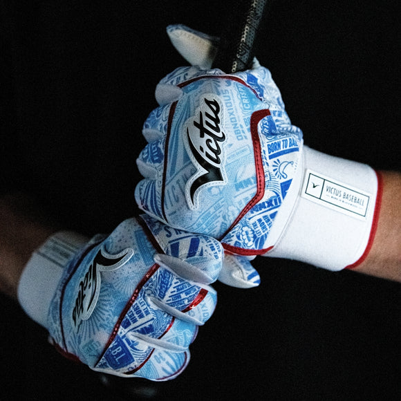 Close-up of a player holding a bat while wearing the Victus NOX Full Wrap BG Adult Batting Glove - Red/Royal/Columbia