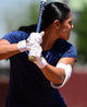 Fastpitch player hitting while wearing theEvoshield Carbyne Adult Batting Glove with Strap - White