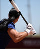 Fastpitch player hitting while wearing the Evoshield Carbyne Adult Batting Glove with Strap - White