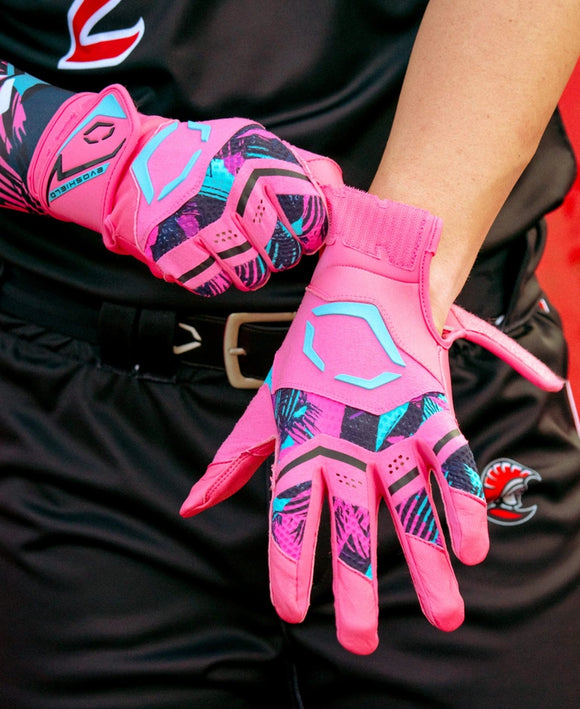 Player putting on the Evoshield Adult X-SRZ™ Miami Vice Carbyne Batting Glove - Black/Hot Pink
