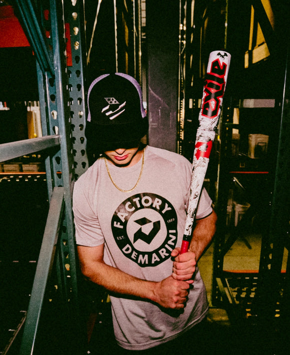 Young player holding the 2026 DeMarini Exile™ Baseball Bat