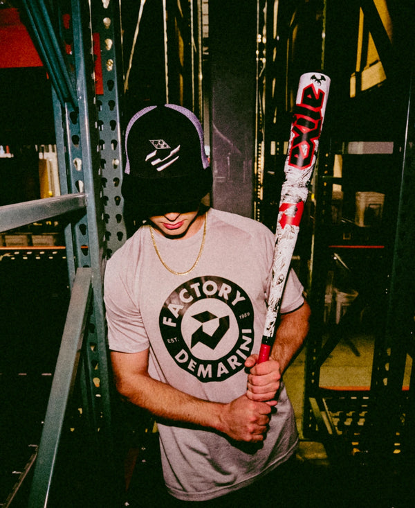 Young player holding the 2026 DeMarini Exile™  Baseball Bat