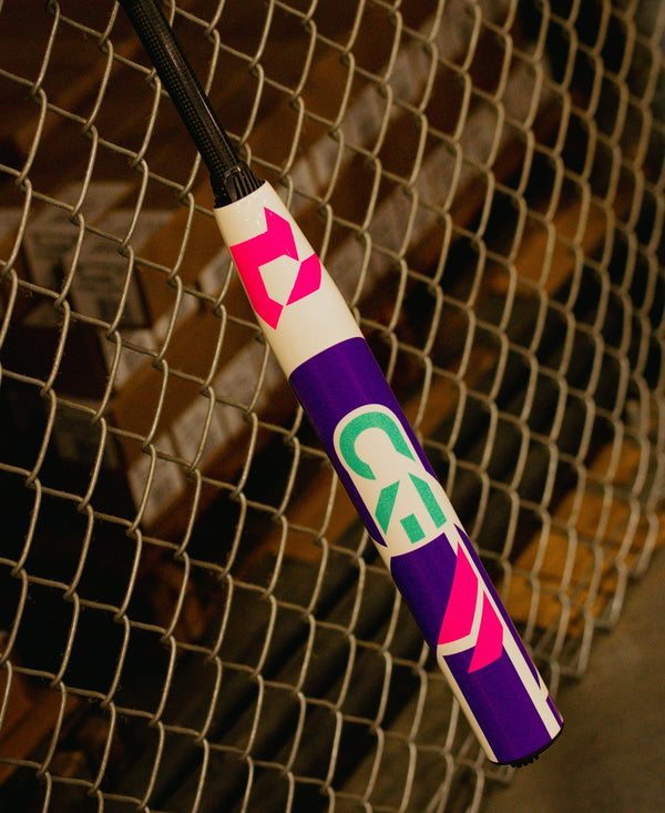 2026 DeMarini CF® FE -10 Fastpitch Bat hanging on the field fence