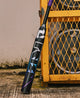 2026 DeMarini Prism+™ FE -11 Fastpitch Bat resting against a metal crate