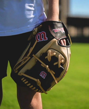 Player in the field using the Wilson A900® PF115 Pedroia Fit™ 11.5" Baseball Glove