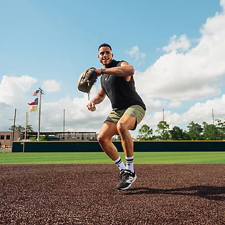 Player in the field wearing the New Balance Fresh Foam 3000 v7 Molded Cleat - Black w/ White