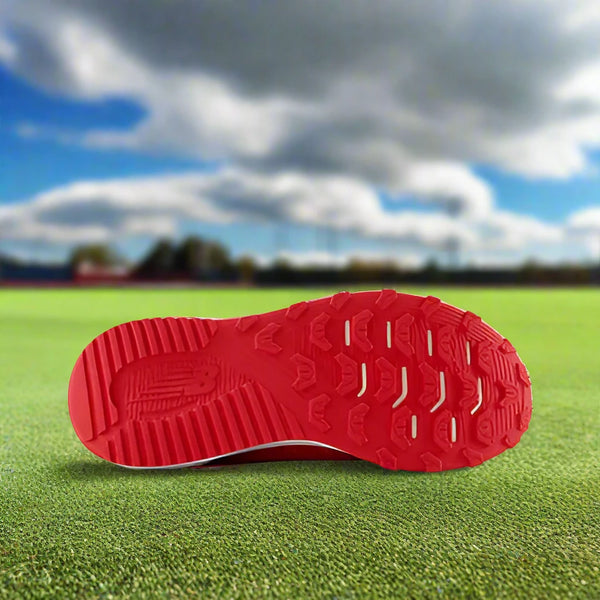 Sole of the New Balance Dynasoft 4040v7 Youth Turf Trainer - Red