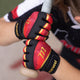 Player holding a bat whild wearing the Marucci Foxtrot Tee Ball Youth Batting Glove - Black/Red
