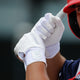 Player batting while wearing the Marucci Luxe Adult Batting Glove - White