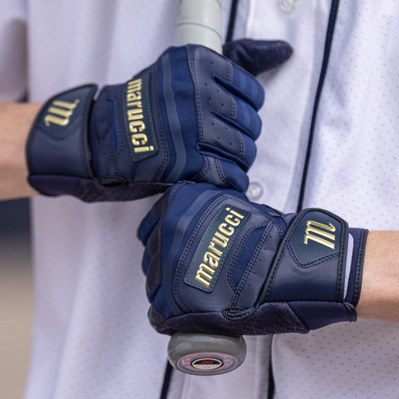 Player holding a bat whild wearing theMarucci Pittards® Reserve Adult Batting Glove