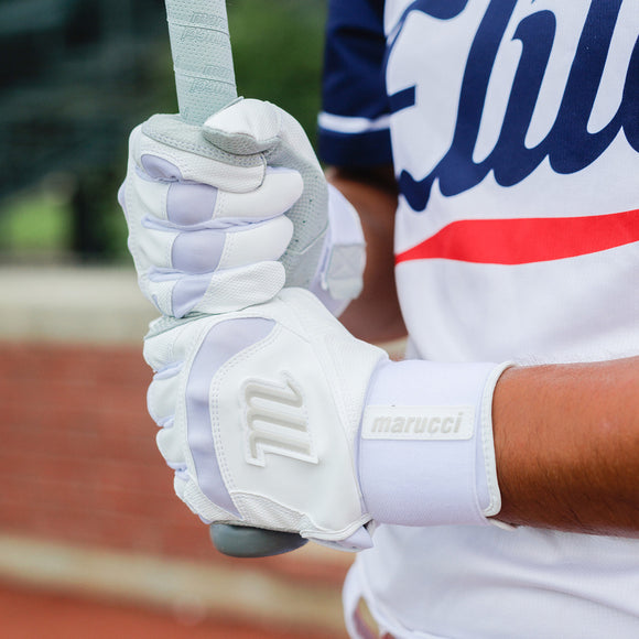 Player holding a bat while wearing the Marucci Signature Full Wrap Adult Batting Glove