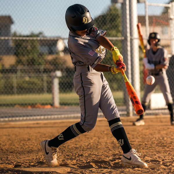 Young player in action hitting with the 2025 Easton Hype Fire® USA -8 Baseball Bat