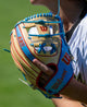 Player in the field wearing the Wilson 2027 A2K® 1786 11.5" Baseball Glove - Blonde/Sky Blue