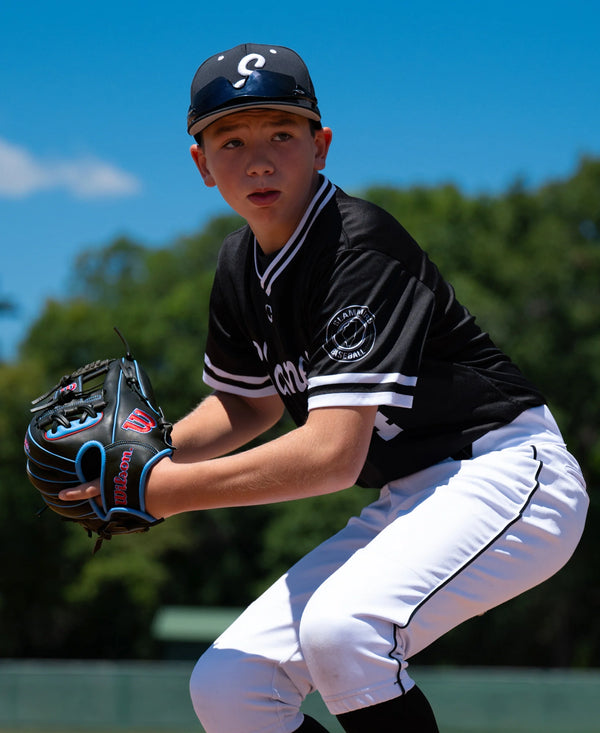 Young player in the field using the Wilson 2027 A1000® DP15 11.5" Baseball Glove