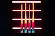 2027 Easton Hype Fire® USA Baseball Bats standing upright together in front of bright neon lights