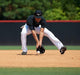 Player fielding a ground ball while wearing the Mizuno Premier Pro Baseball Long Pant G2