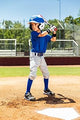 Young player batting while wearing the Mizuno Premier Short Baseball Pant