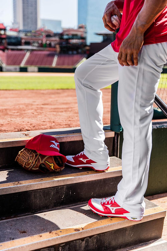 Player in the dugout wearing the Mizuno Premier Pro Baseball Long Pant G2