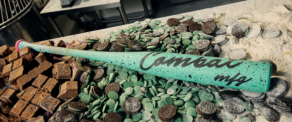 2026 Combat MFG Cookie Jar Mint Chip Spec-A1 -3 BBCOR Baseball Bat laying in a confectioners table