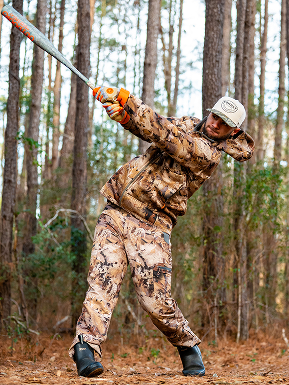 Player in hunting gear swinging the 2026 Combat MFG Outdoor Spec-A1 "Shooters Shoot" -3 BBCOR Baseball Bat in the woods