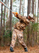 Player in hunting gear swinging the 2026 Combat MFG Outdoor Spec-A1 "Shooters Shoot" -3 BBCOR Baseball Bat in the woods