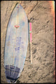 2026 Combat MFG Spec H1 Hybrid Coastal Collective Uluwatu -3 BBCOR Baseball Bat laying on the sand near a surfboard