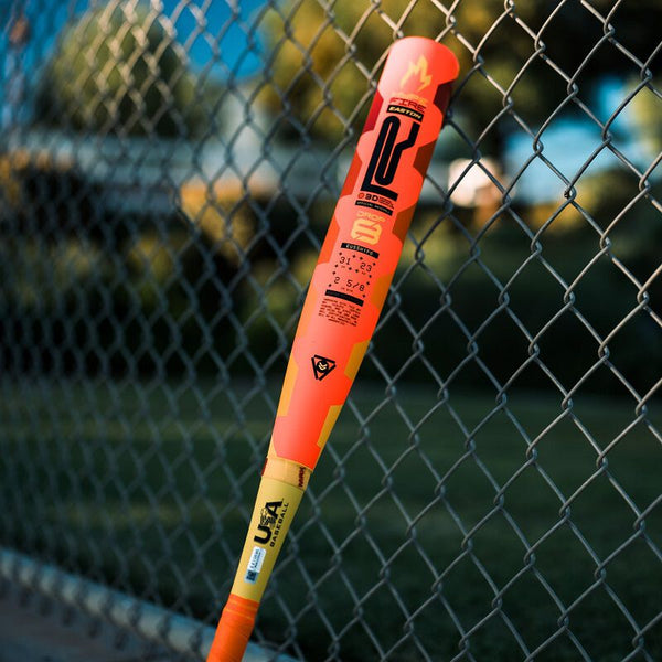 2025 Easton Hype Fire® USA -8 Baseball Bat resting against a fence