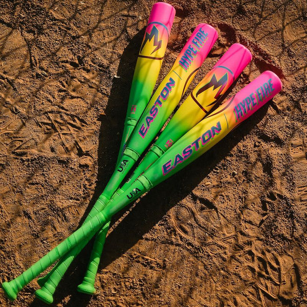 2026 Easton Hype Fire® USA Baseball Bats displayed on the baseball field dirt