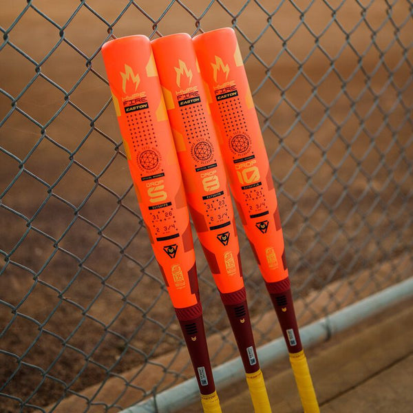 Three 2025 Easton Hype Fire® USSSA Baseball Bats leaning on a fence