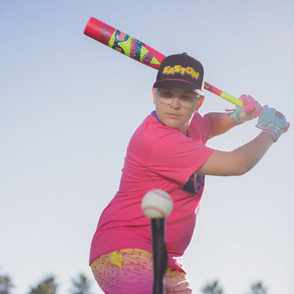 Player hitting off a tee with the 2026 Easton Spring Break Pink Dub USSSA Baseball Bat