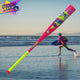 Player running on the beach with the 2026 Easton Spring Break Pink Dub USSSA -10 Baseball Bat in the foreground
