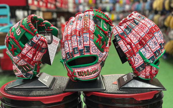 Trio of Wilson A2000 1975 Christmas Sweater 11.75" Baseball Gloves - GOTM December 2025, on display
