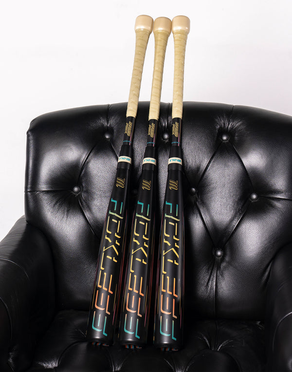 2027 Marucci CATX RCKLESS Hybrid Puck -3 BBCOR Baseball Bats resting on a lounge chair