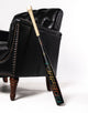2027 Marucci CATX RCKLESS Torpedo Puck -3 BBCOR Baseball Bat resting against a lounge chair