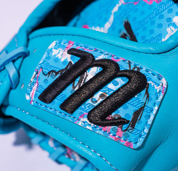 Close-up of the "M" logo on the wrist of the Marucci Nightshift Series Blue Lizard 43A2 11.5" Baseball Glove