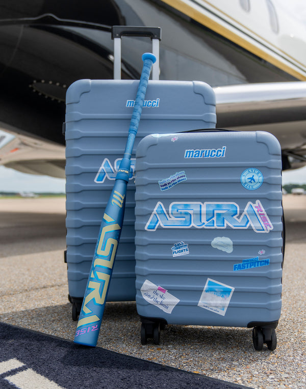 Marucci Asura Rise Fastpitch Bat modeled with luggage on an airport runway