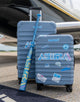 Marucci Asura Rise Fastpitch Bat modeled with luggage on an airport runway