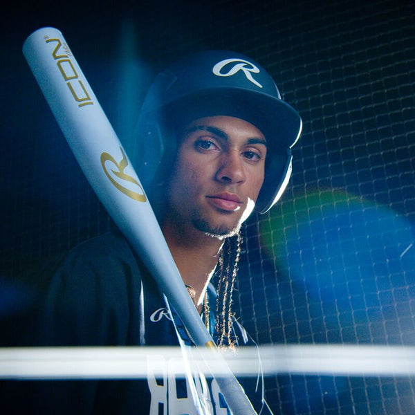 Player in the dugout holding the 2026 Rawlings ICON™ The Chosen One -3 BBCOR Baseball Bat
