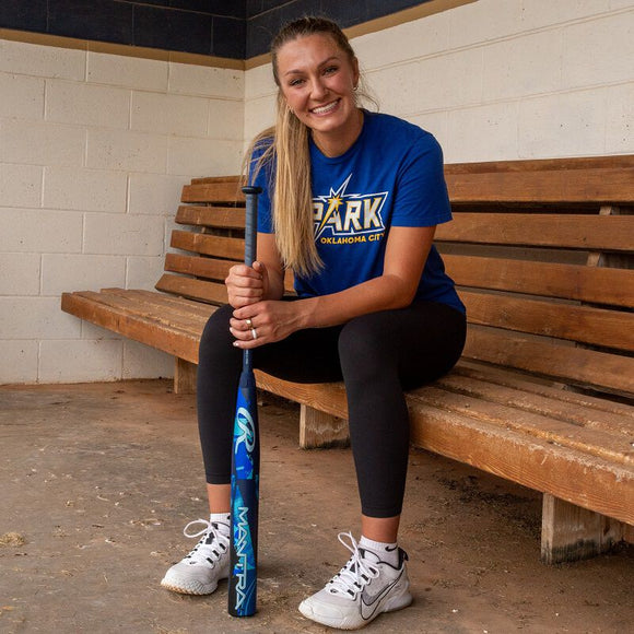 Pro fastpitch star Kinzie Hansen in the dugout with the 2026 Rawlings Mantra™ Fastpitch Bat