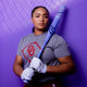 College player Ella Parker holding the 2027 Rawlings Halo Fastpitch Bat