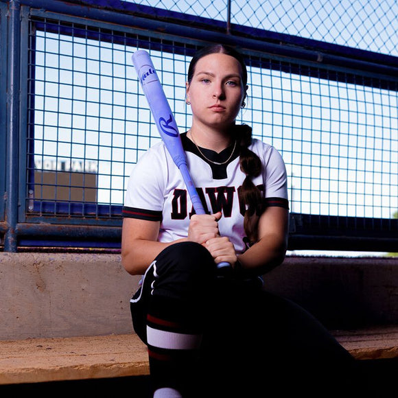 College player Juliana Hutchens in the dugout with the 2027 Rawlings Halo Fastpitch Bat 