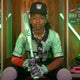 Young player sitting in a locker holding the 2026 Rawlings ICON™ USSSA Baseball Bat