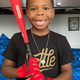 Young player posing while wearing the Warstic Workman3 Batting Glove "Red/Black"