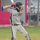 Young player batting with the Warstic Workman3 Batting Glove "Battle Pink"